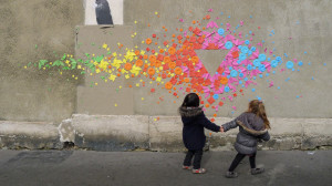 Children play in front of Origami street art